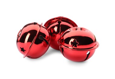 Shiny red sleigh bells on white background