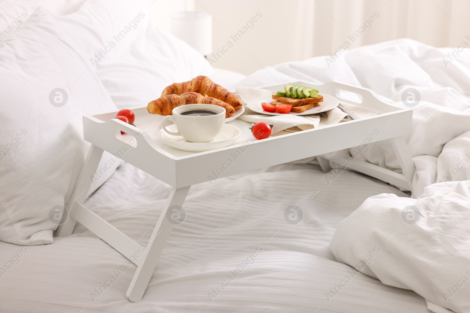 Good morning. Tray with tasty breakfast on bed at home Photo of Good morning. Tray with tasty breakfast on bed at home