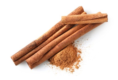 Photo of Dry aromatic cinnamon sticks and powder isolated on white, top view