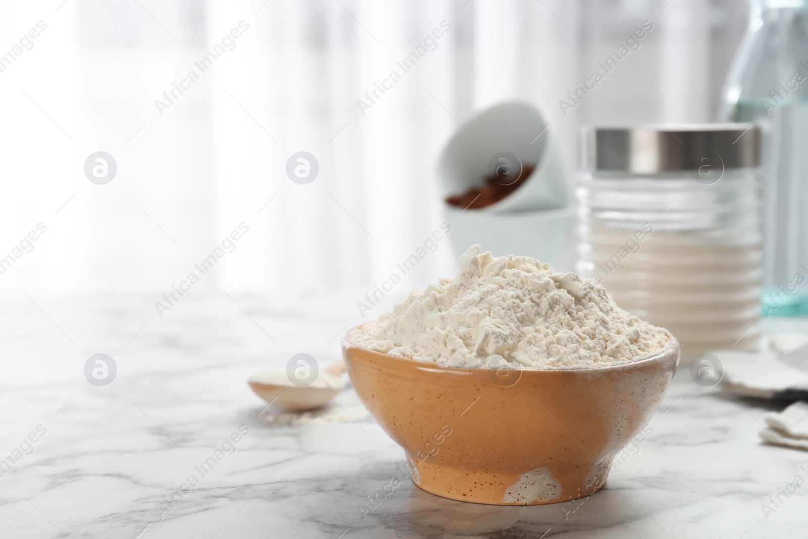 Photo of Bowl with flour on kitchen table