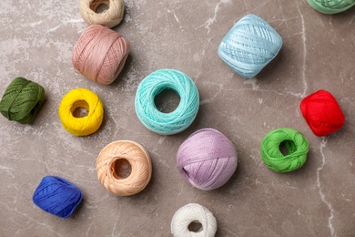 Photo of Color threads on gray background, top view