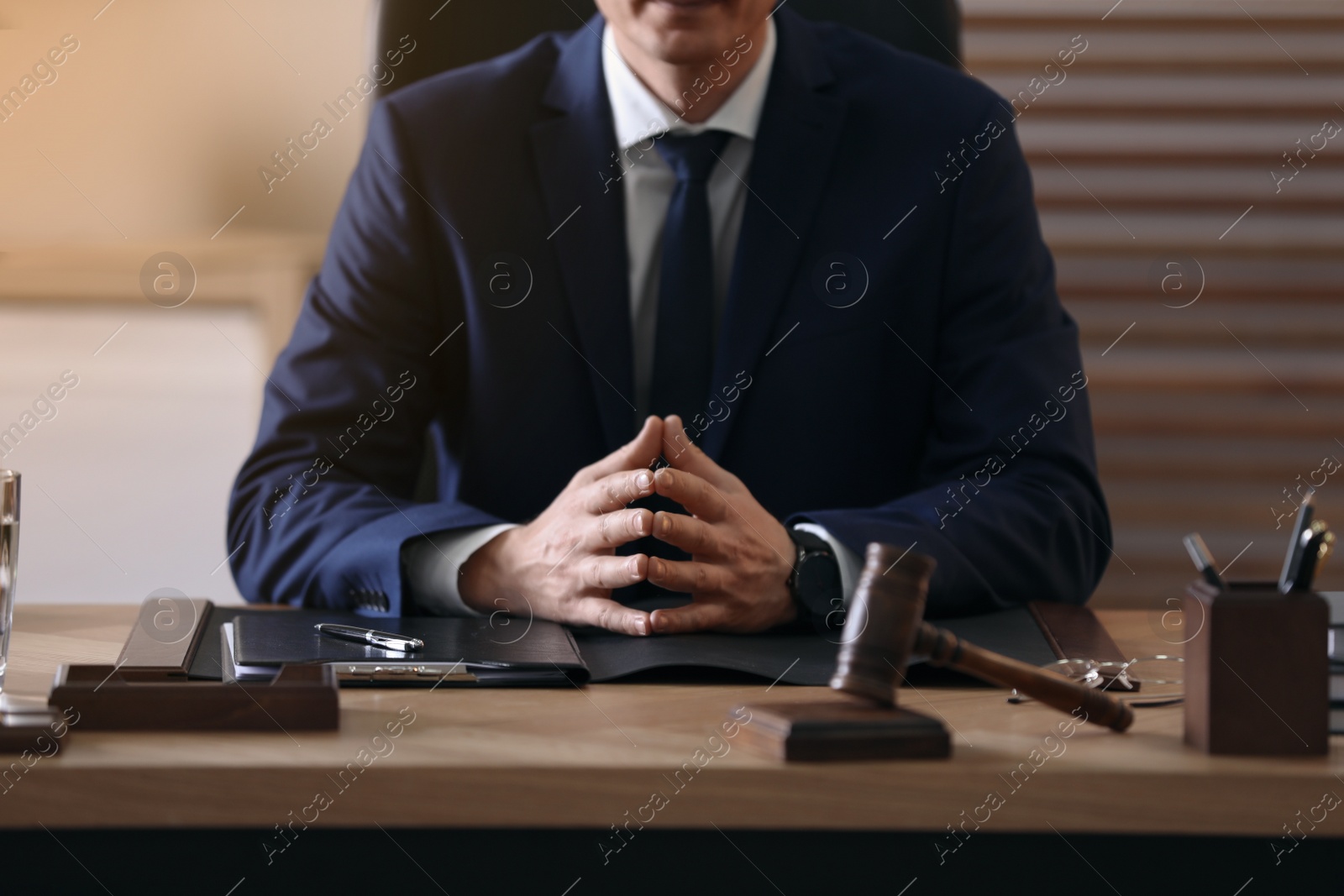 Photo of Male lawyer at table in office, closeup