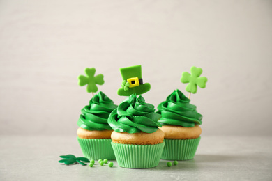 Delicious decorated cupcakes on light table. St. Patrick's Day celebration