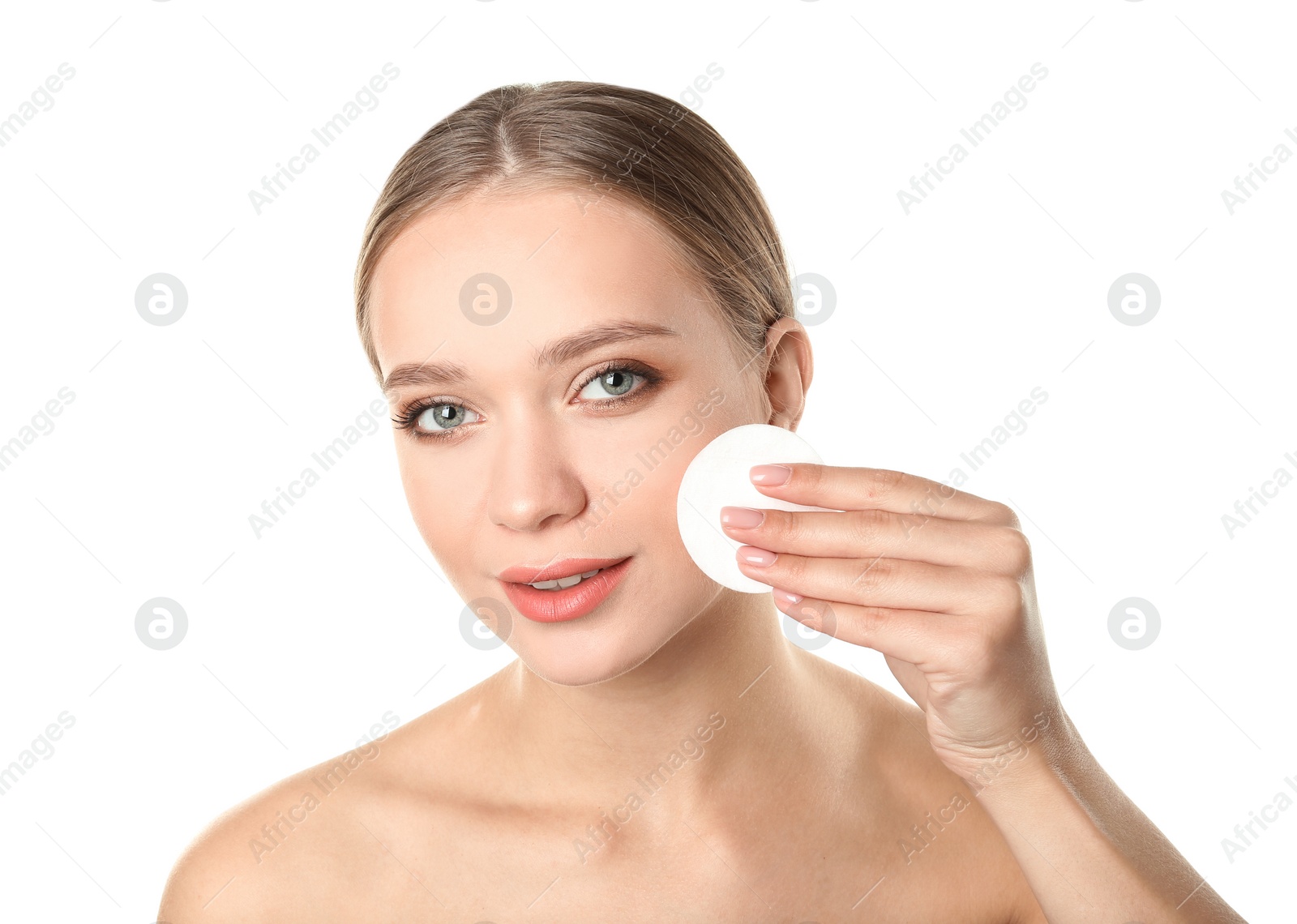 Photo of Portrait of beautiful young woman removing makeup with cotton pad on white background