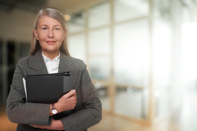 Image of Lawyer, consultant, business owner. Confident woman with file folders indoors, space for text