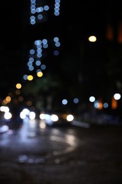 Photo of Blurred view of city street with lights at night. Bokeh effect