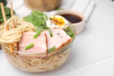 Photo of Noodle soup. Delicious ramen with meat on white table, closeup. Space for text