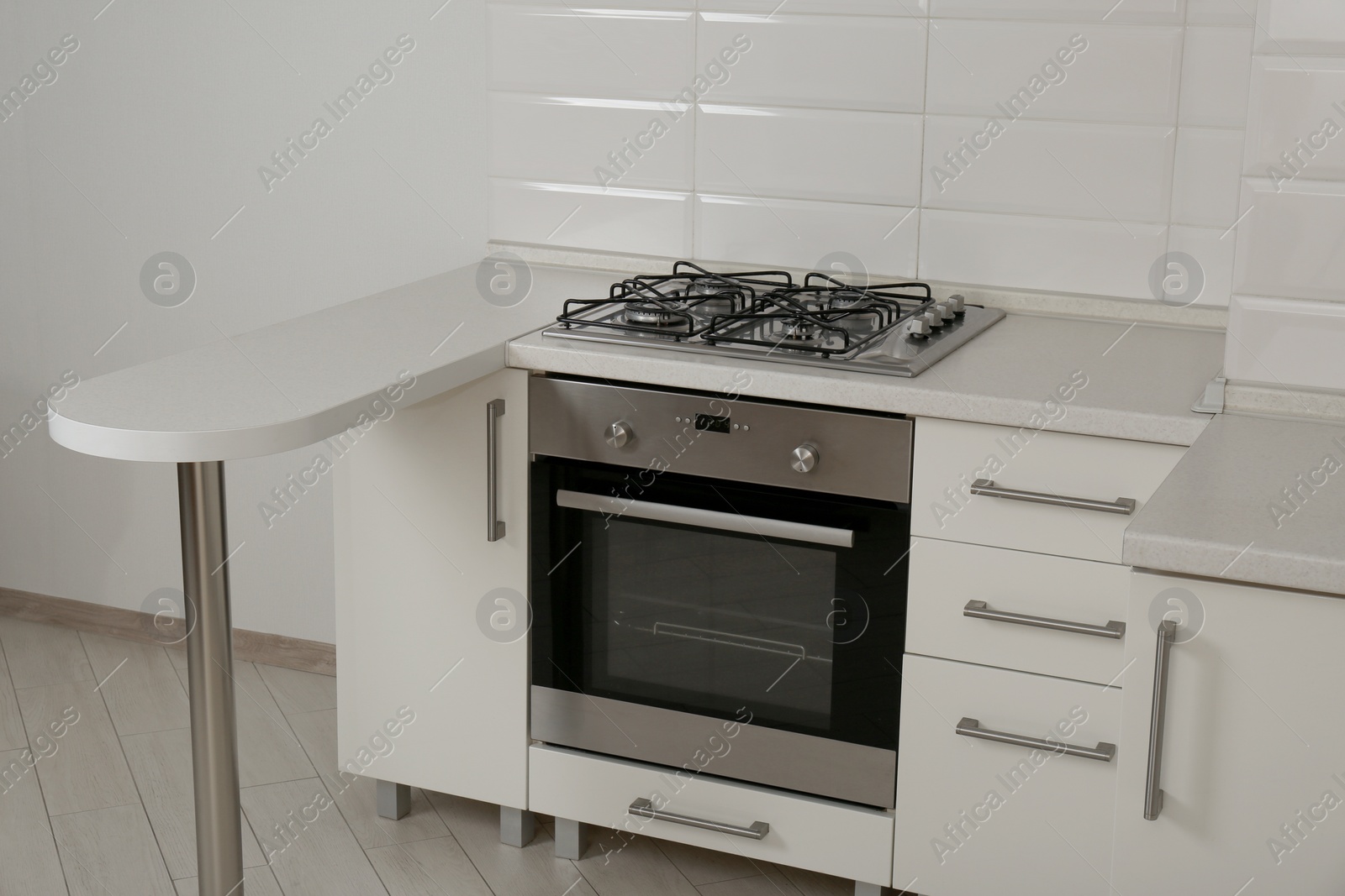 Photo of New gas stove and oven in stylish kitchen