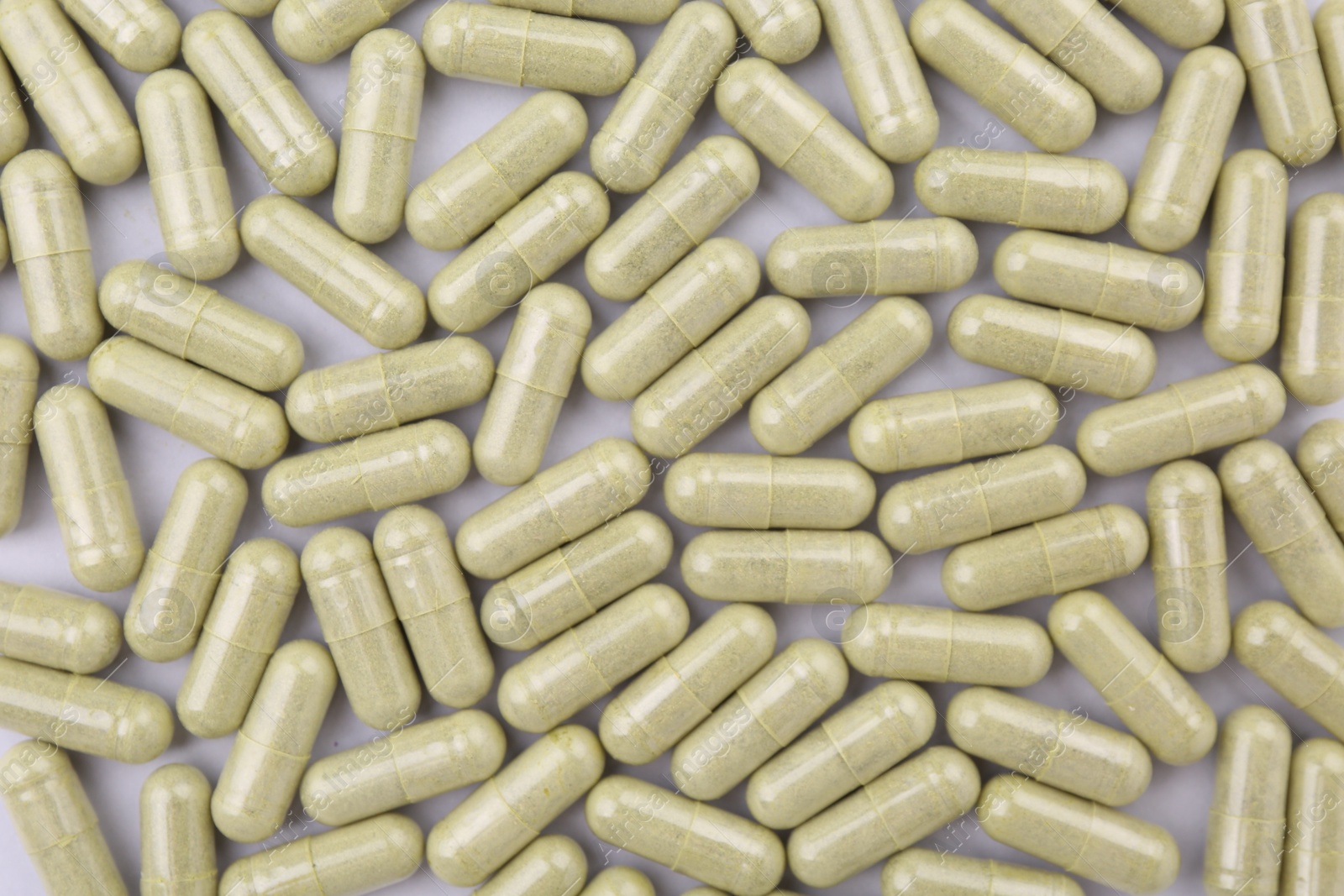 Photo of Many vitamin capsules on white background, flat lay