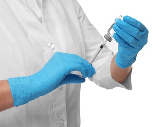 Photo of Doctor filling syringe with medication from glass vial on white background, closeup