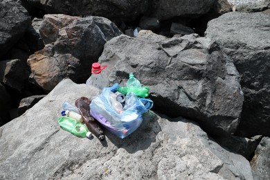 Photo of Garbage on stones outdoors. Environmental Pollution concept