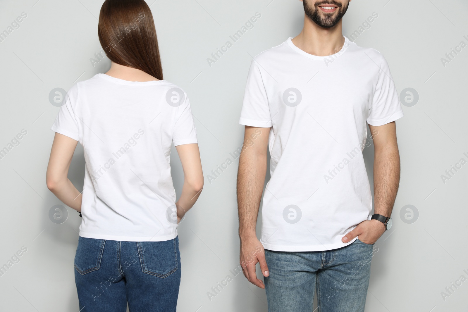 Photo of Young people in t-shirts on light background, closeup. Mock up for design