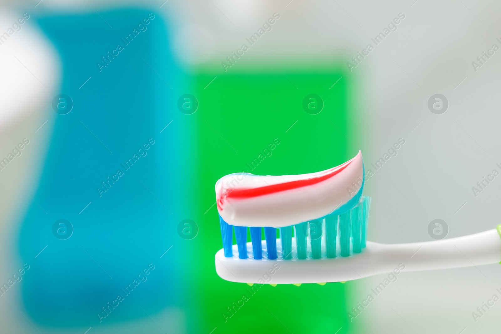 Photo of Toothbrush with paste against blurred background, closeup