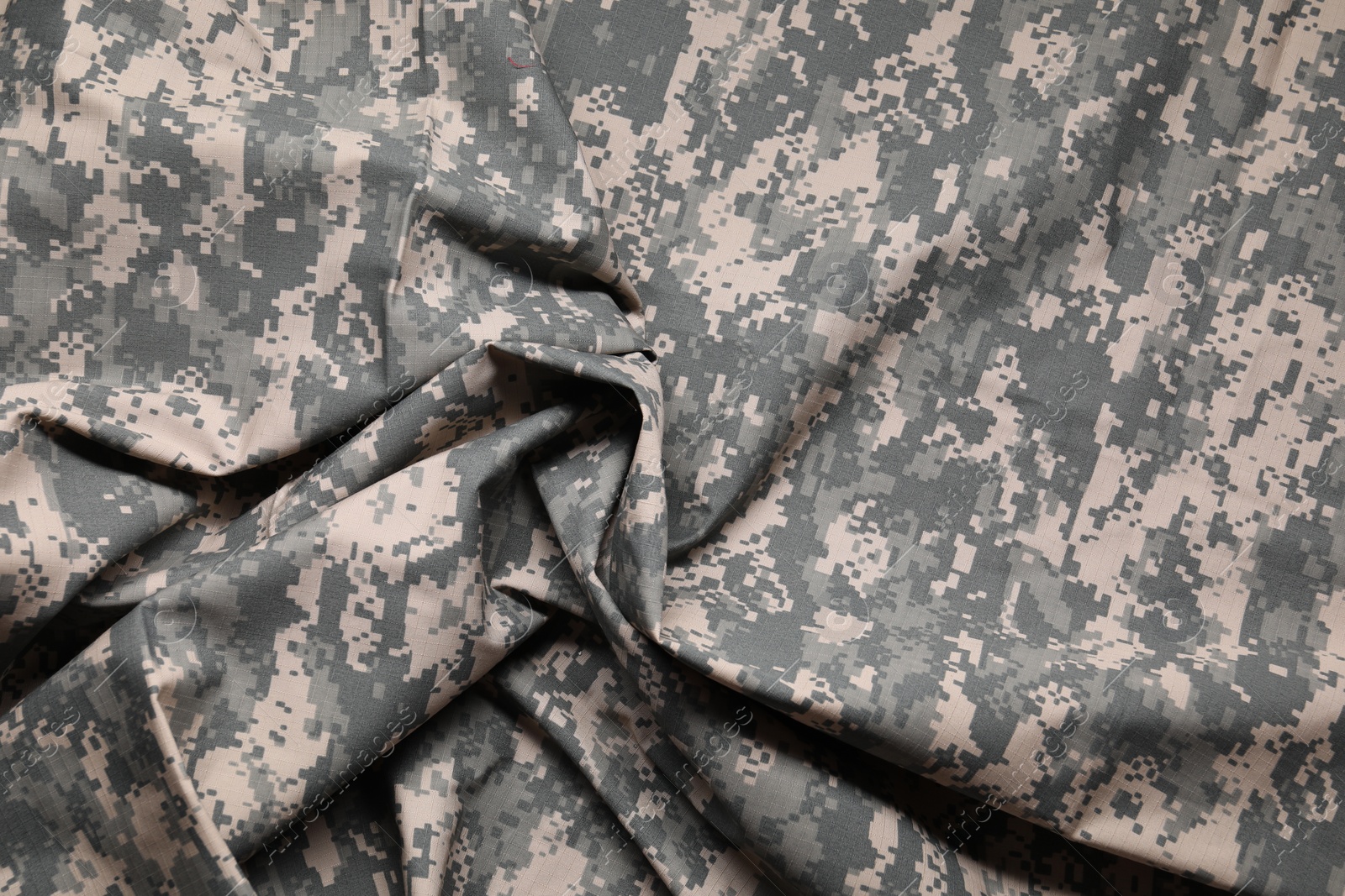 Photo of Texture of crumpled camouflage fabric as background, top view