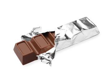 Delicious chocolate bar wrapped in foil on white background