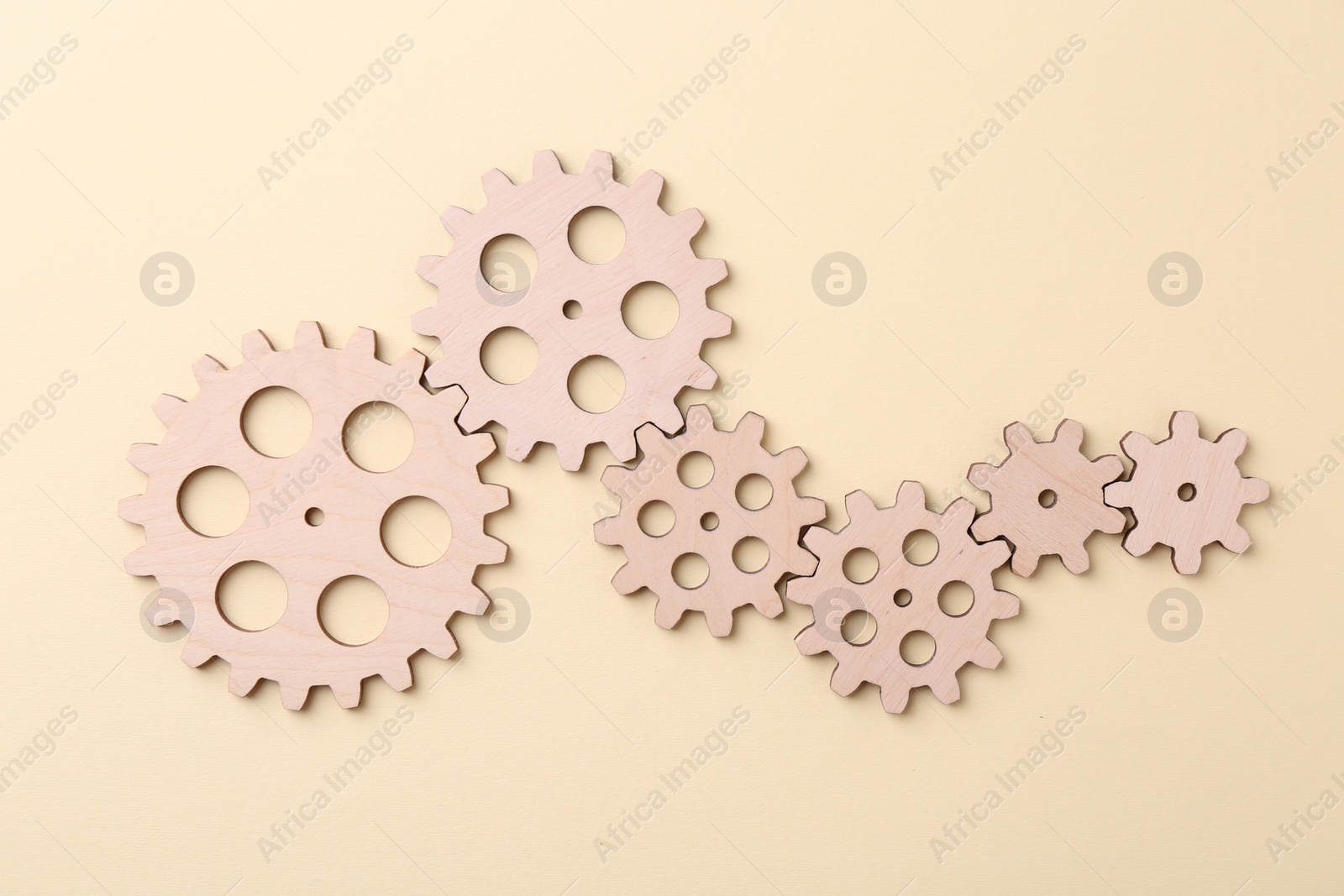 Photo of Business process organization and optimization. Scheme with wooden figures on beige background, top view
