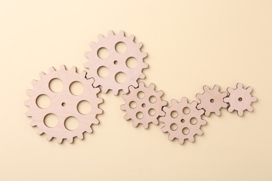 Photo of Business process organization and optimization. Scheme with wooden figures on beige background, top view