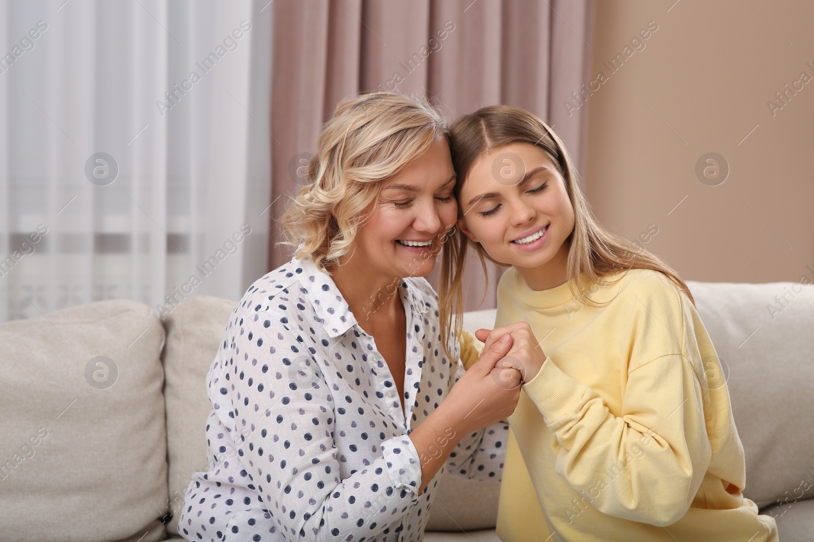 Photo of Young woman with her mom at home. Happy Mother's Day