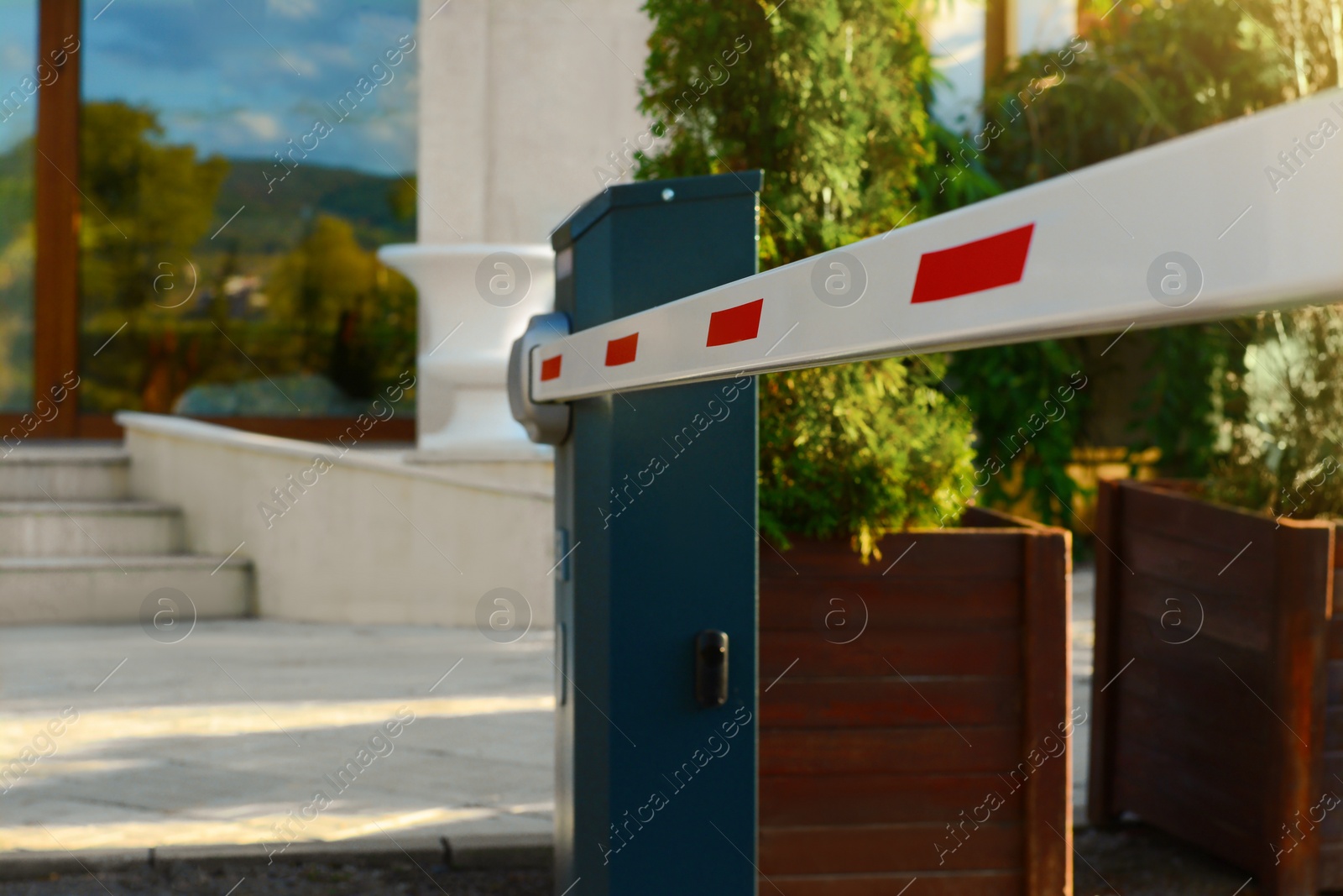 Photo of Closed boom barrier on autumn day outdoors, closeup. Space for text