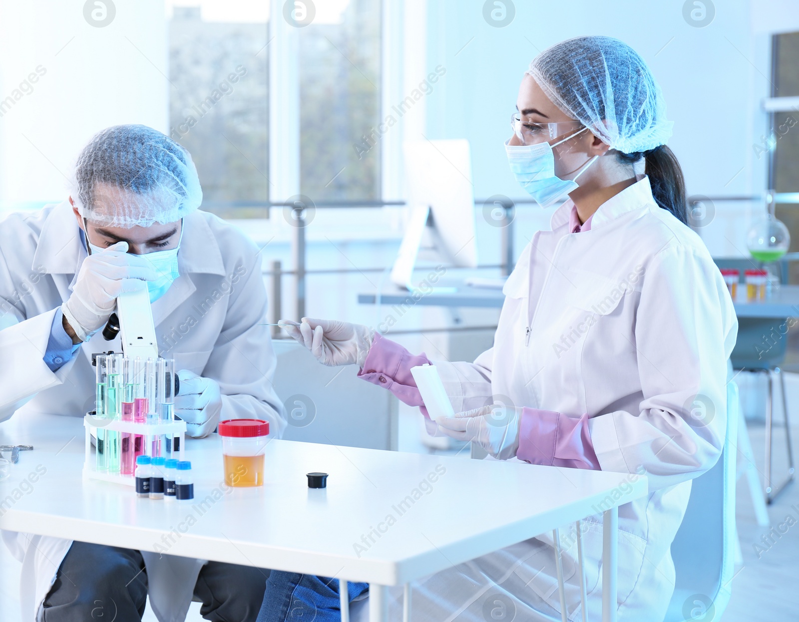 Photo of Young scientists working in laboratory. Chemical analysis