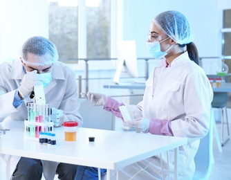 Photo of Young scientists working in laboratory. Chemical analysis