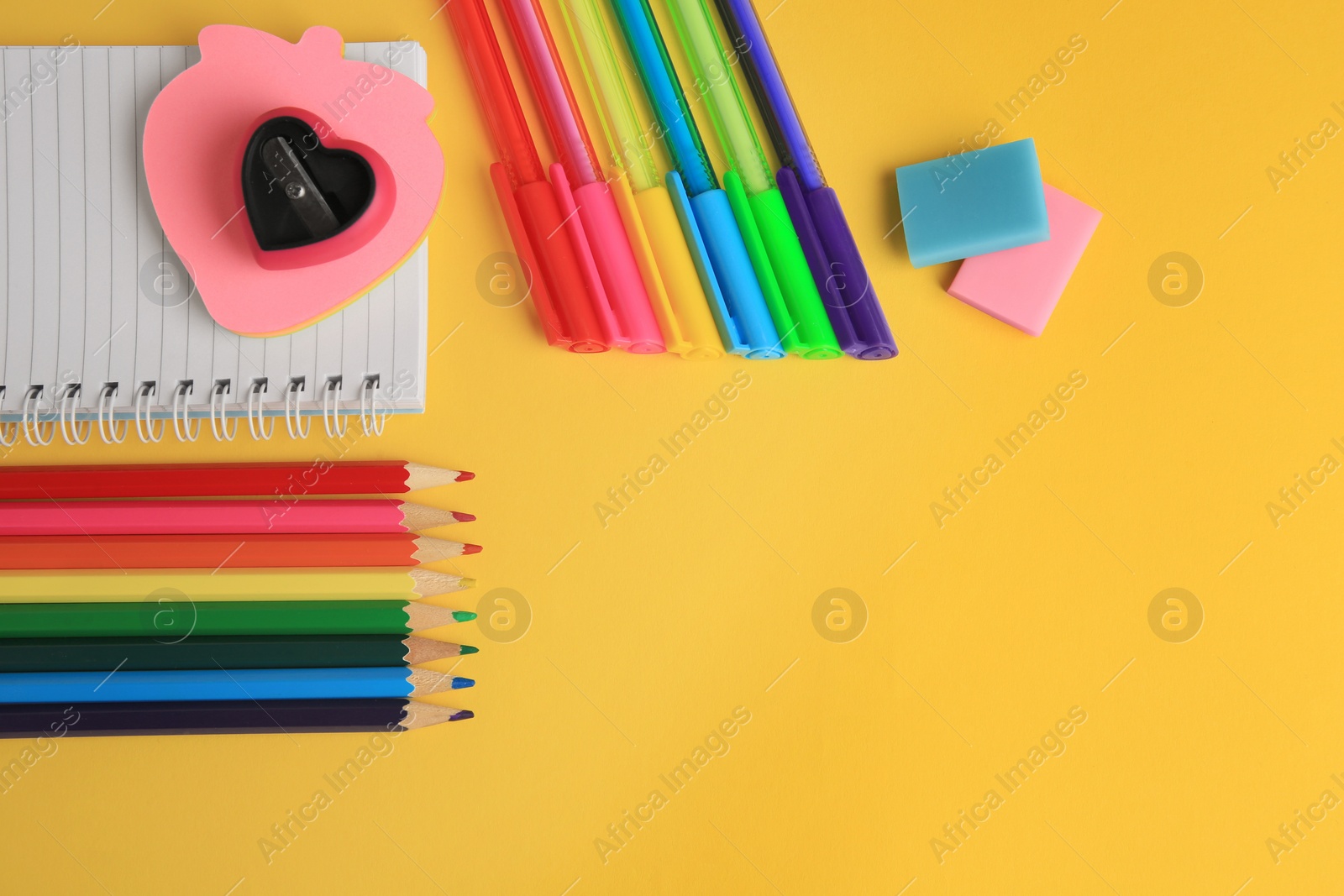 Photo of Flat lay composition with different school stationery on yellow background, space for text. Back to school