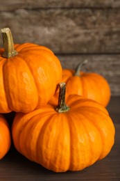 Photo of Fresh ripe pumpkins on wooden table, closeup