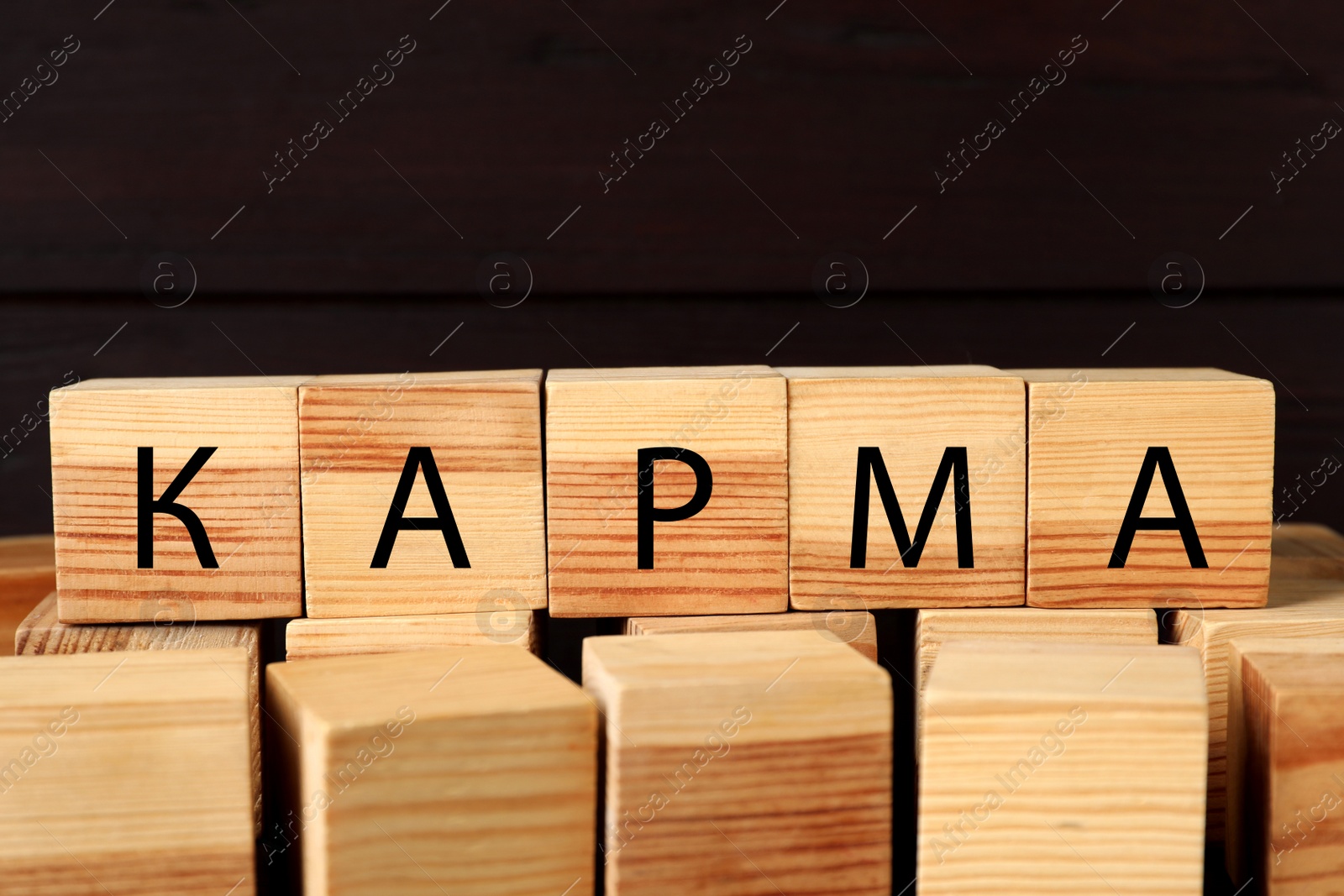 Photo of Word Karma made of cubes with letters on dark background