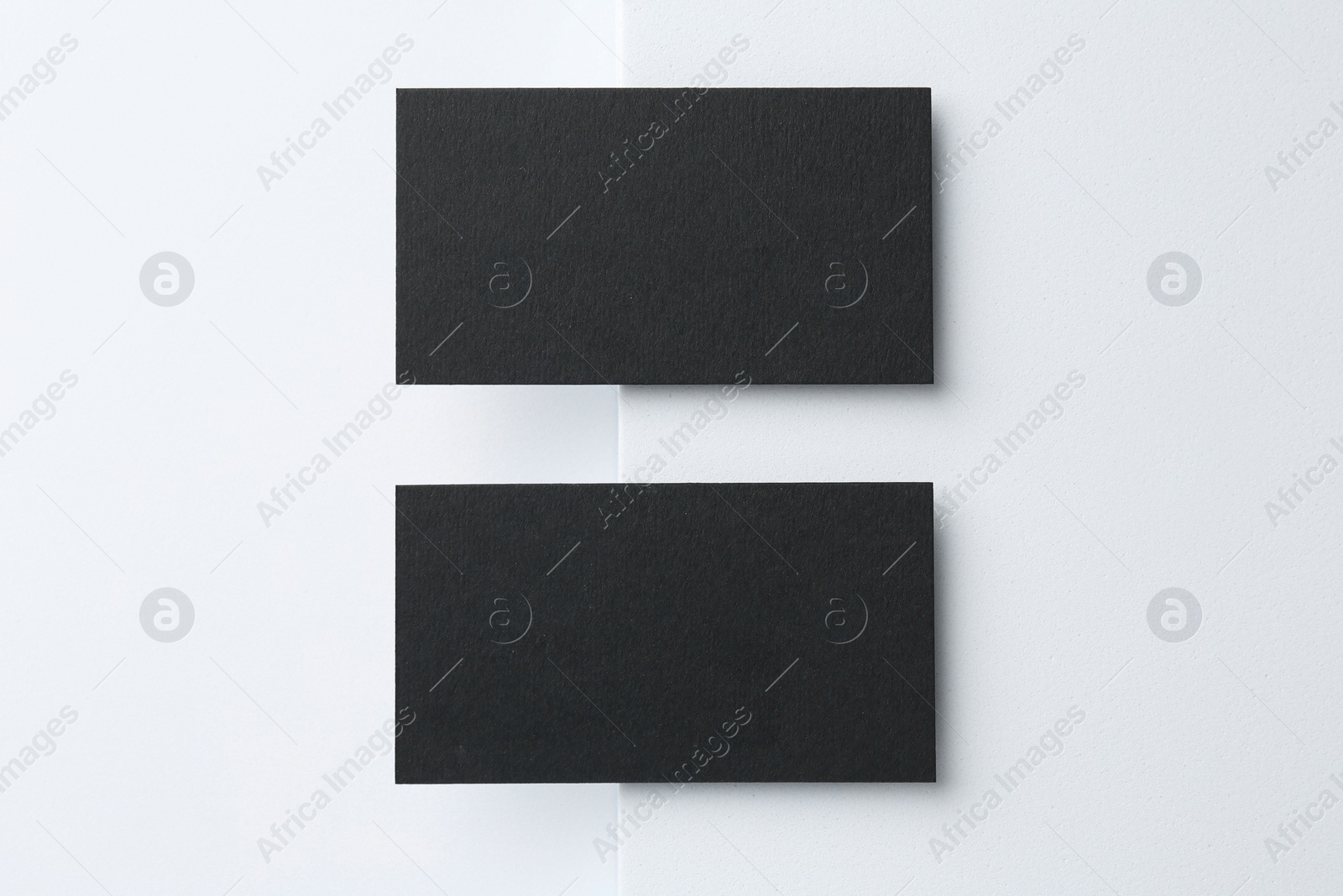 Photo of Blank black business cards on white background, top view. Mockup for design