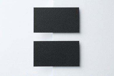 Photo of Blank black business cards on white background, top view. Mockup for design