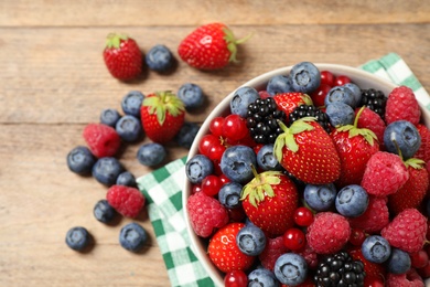 Photo of Mix of ripe berries on wooden table, flat lay