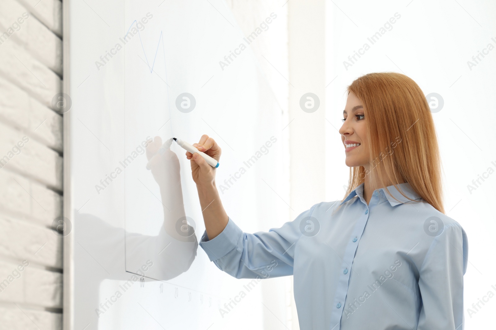 Photo of Professional business trainer near whiteboard in office