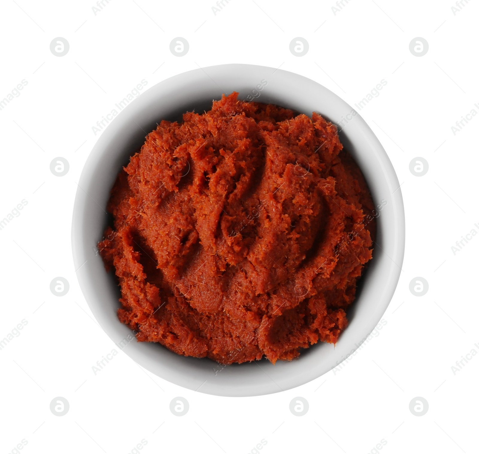 Photo of Tasty curry paste in bowl isolated on white, top view