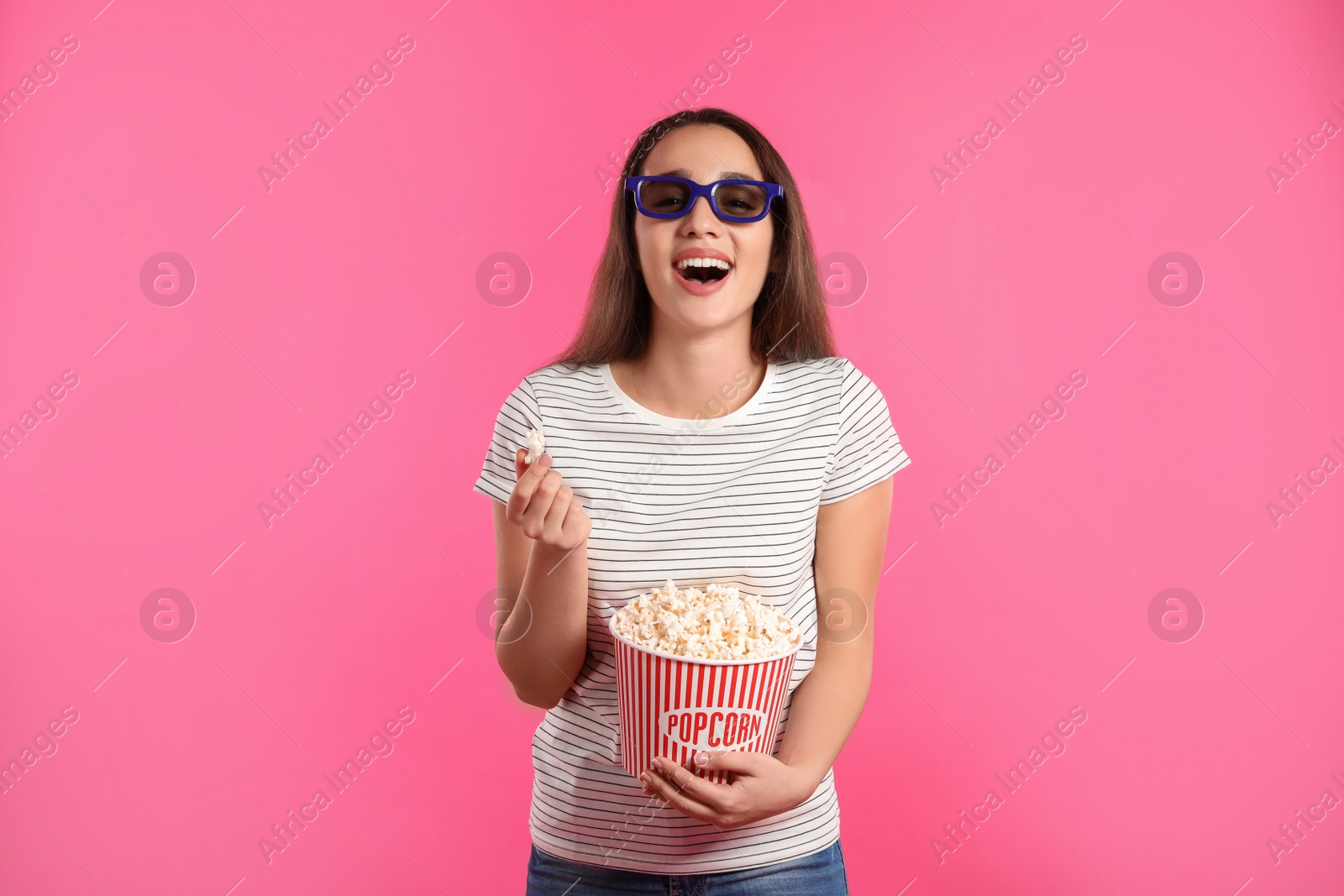 Photo of Woman with 3D glasses and popcorn during cinema show on color background