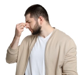 Man suffering from headache on white background