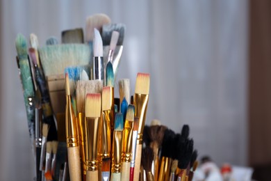 Photo of Many different paintbrushes indoors, closeup. Space for text