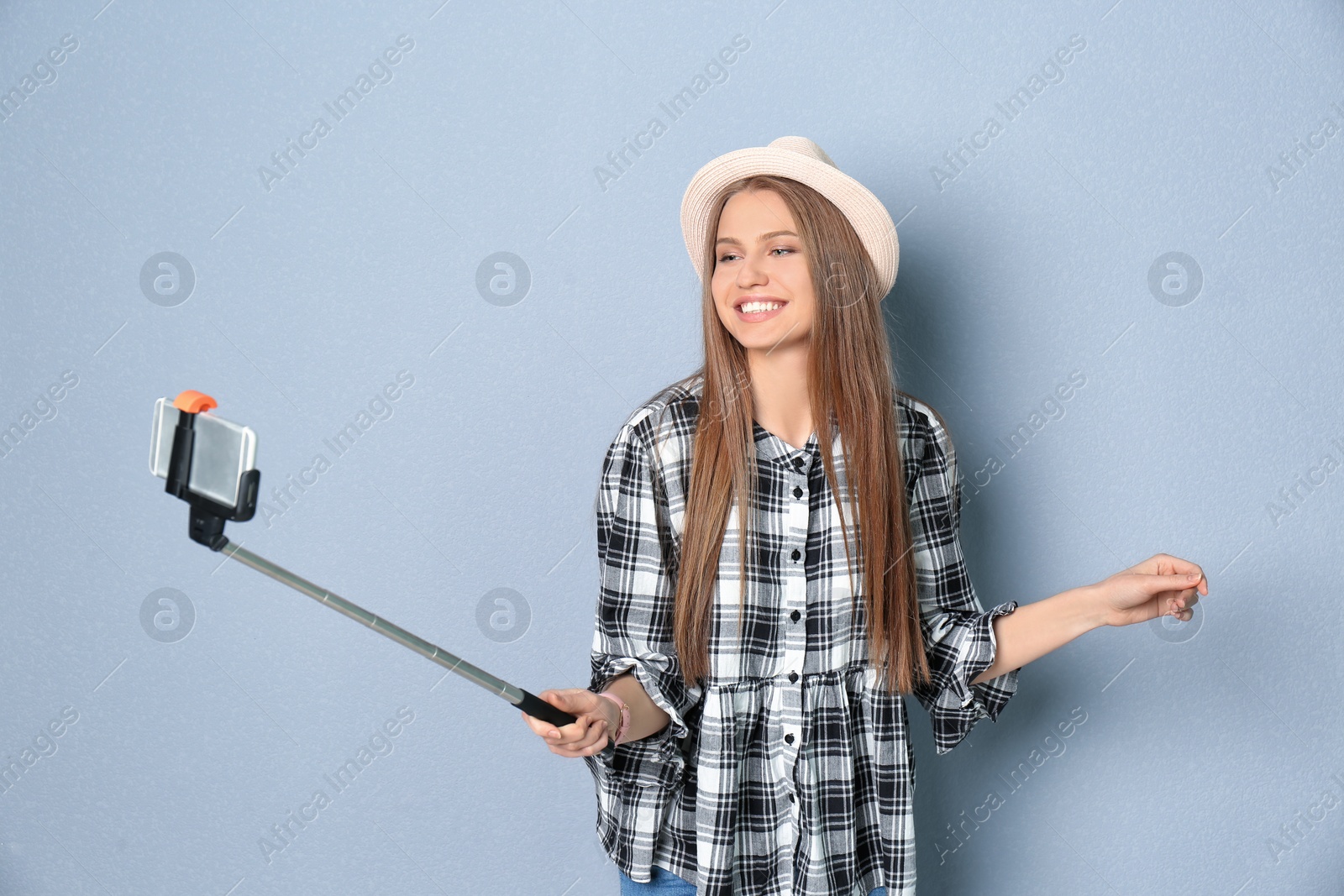 Photo of Young beautiful woman taking selfie against grey background