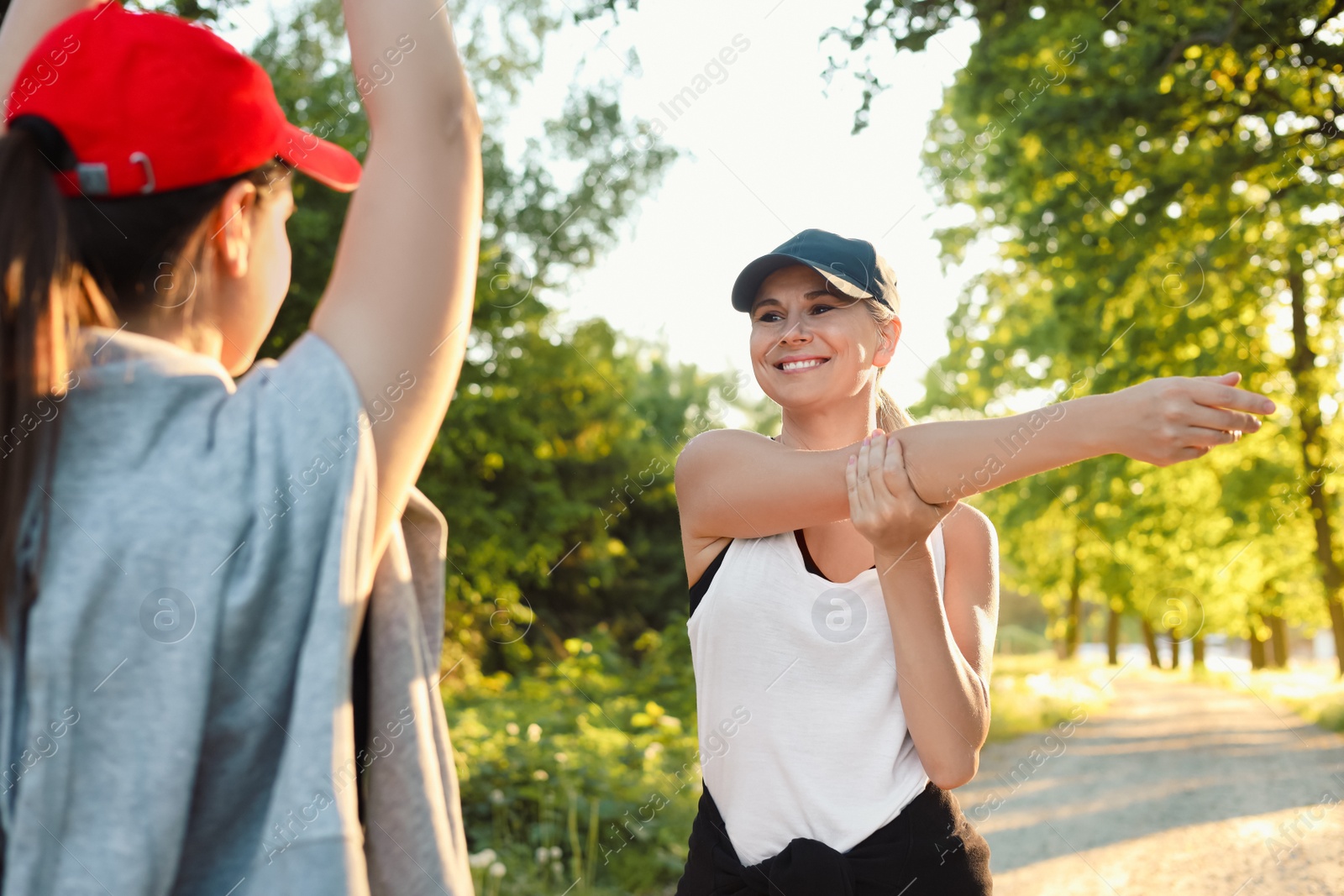 Photo of Women doing morning exercises in green park