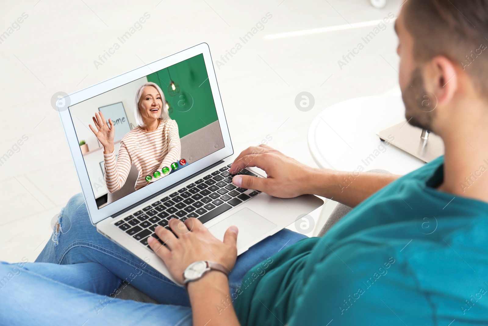 Image of Young man having video chat with his grandmother at home, focus on screen