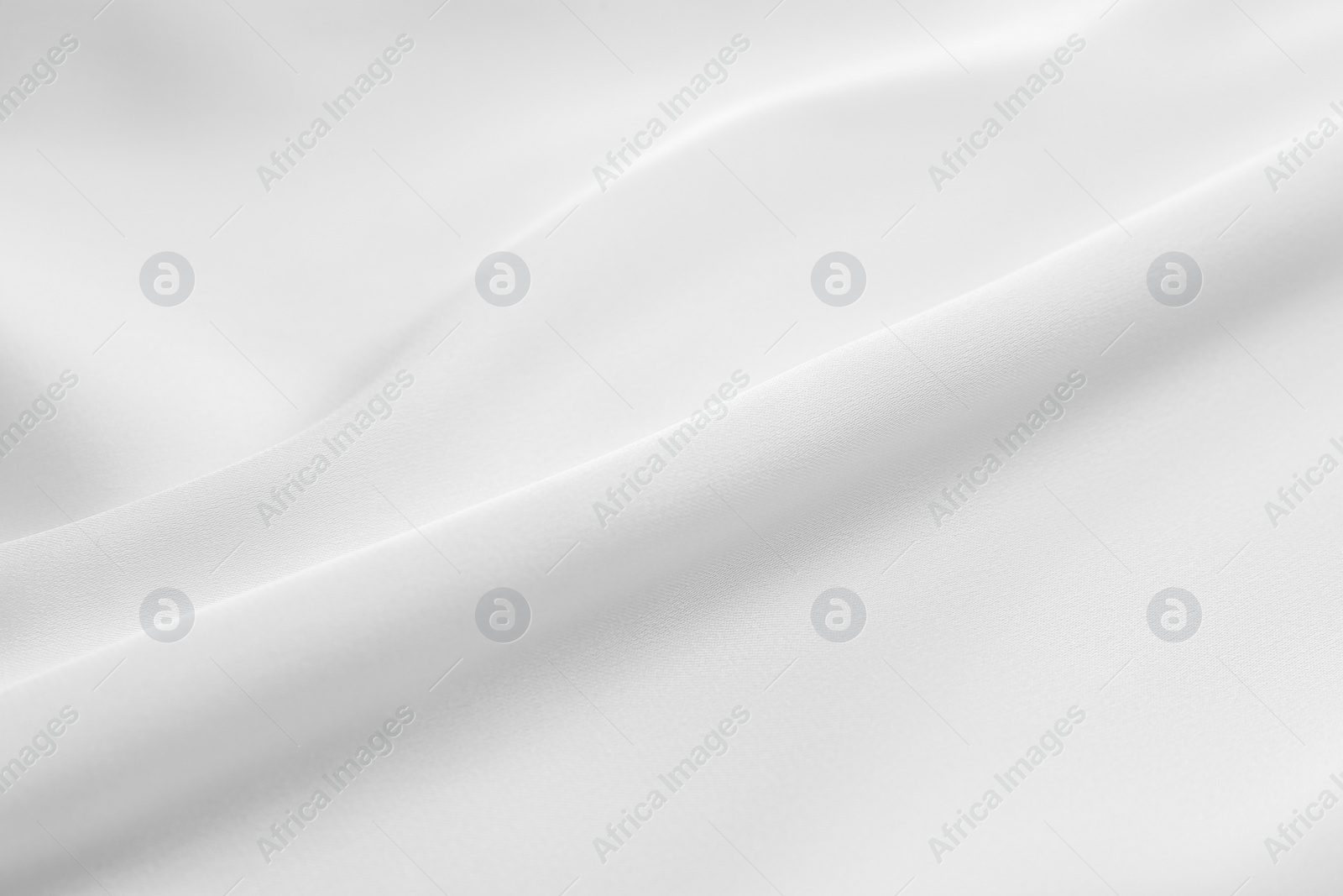 Photo of Texture of white silk ripple fabric as background, closeup