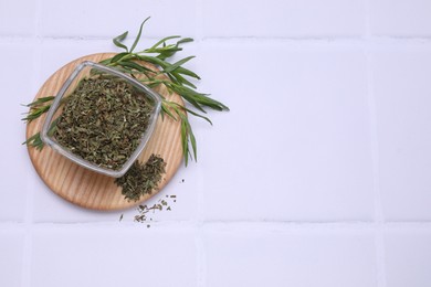 Photo of Dry and fresh tarragon on white tiled table, top view. Space for text