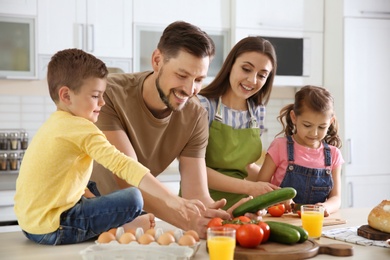 Happy family with children together in kitchen