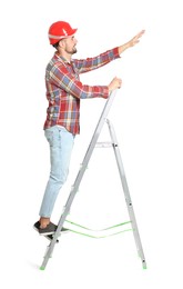 Photo of Young handsome man in hard hat climbing up metal ladder on white background
