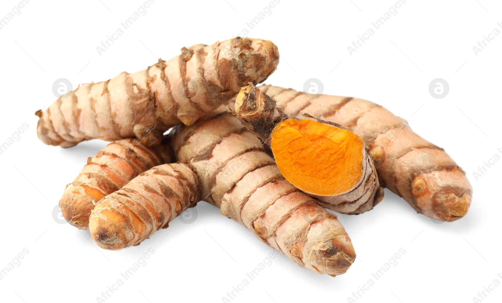 Photo of Whole and cut turmeric roots isolated on white