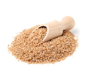 Photo of Pile of dry wheat groats and scoop isolated on white