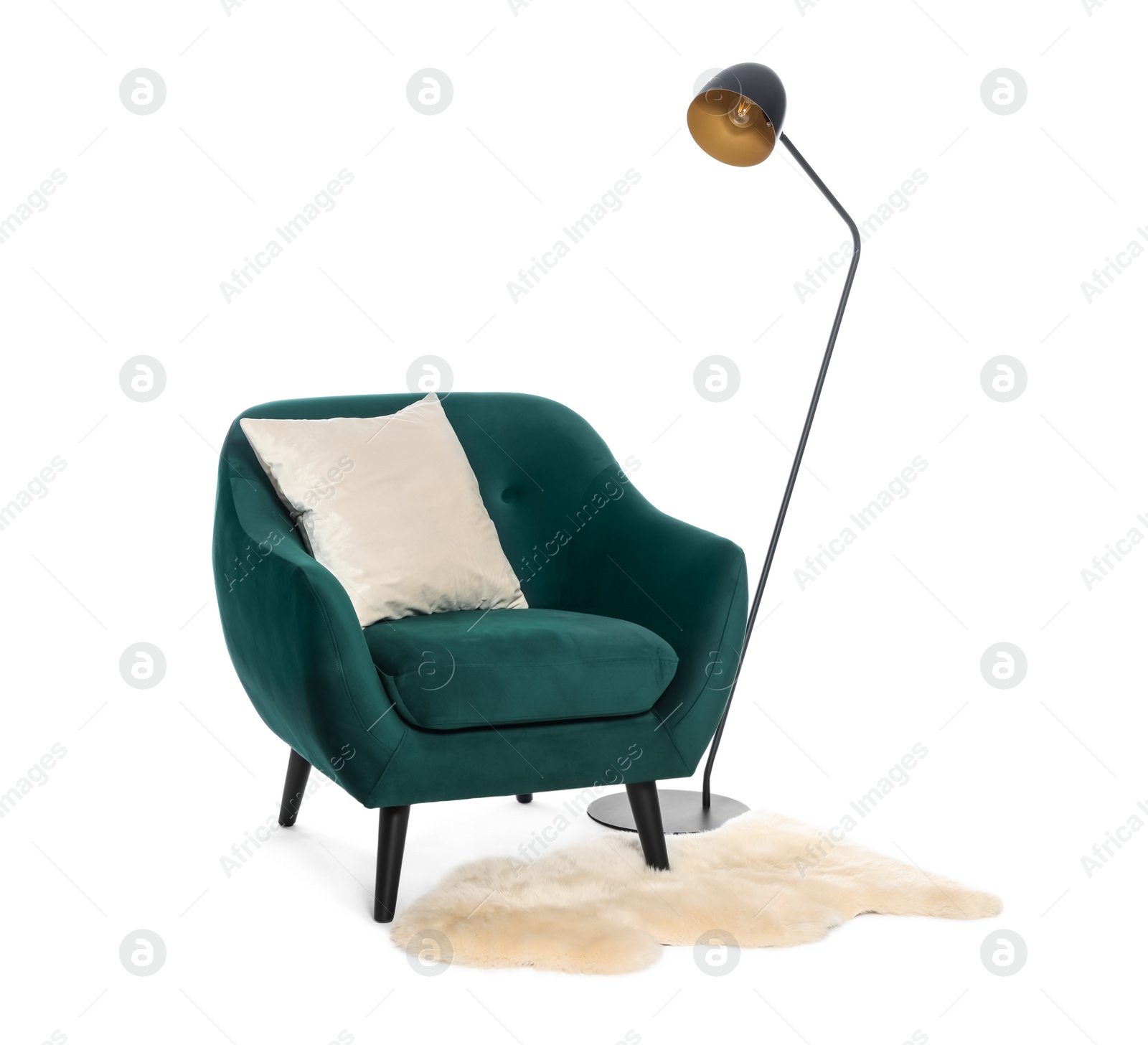 Photo of Stylish comfortable armchair with pillow, lamp and soft rug isolated on white