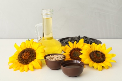 Photo of Composition with sunflower oil on white table