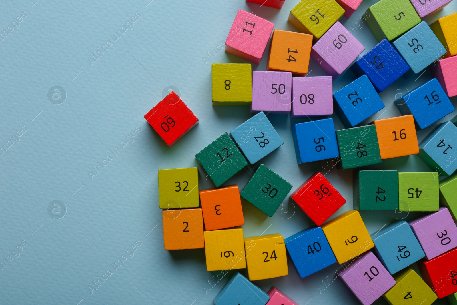 Photo of Wooden cubes with different numbers on light green background, flat lay. Space for text