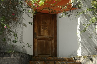 Photo of House entrance with old wooden door outdoors