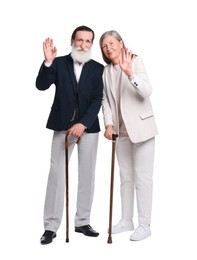 Photo of Senior man and woman with walking canes waving on white background